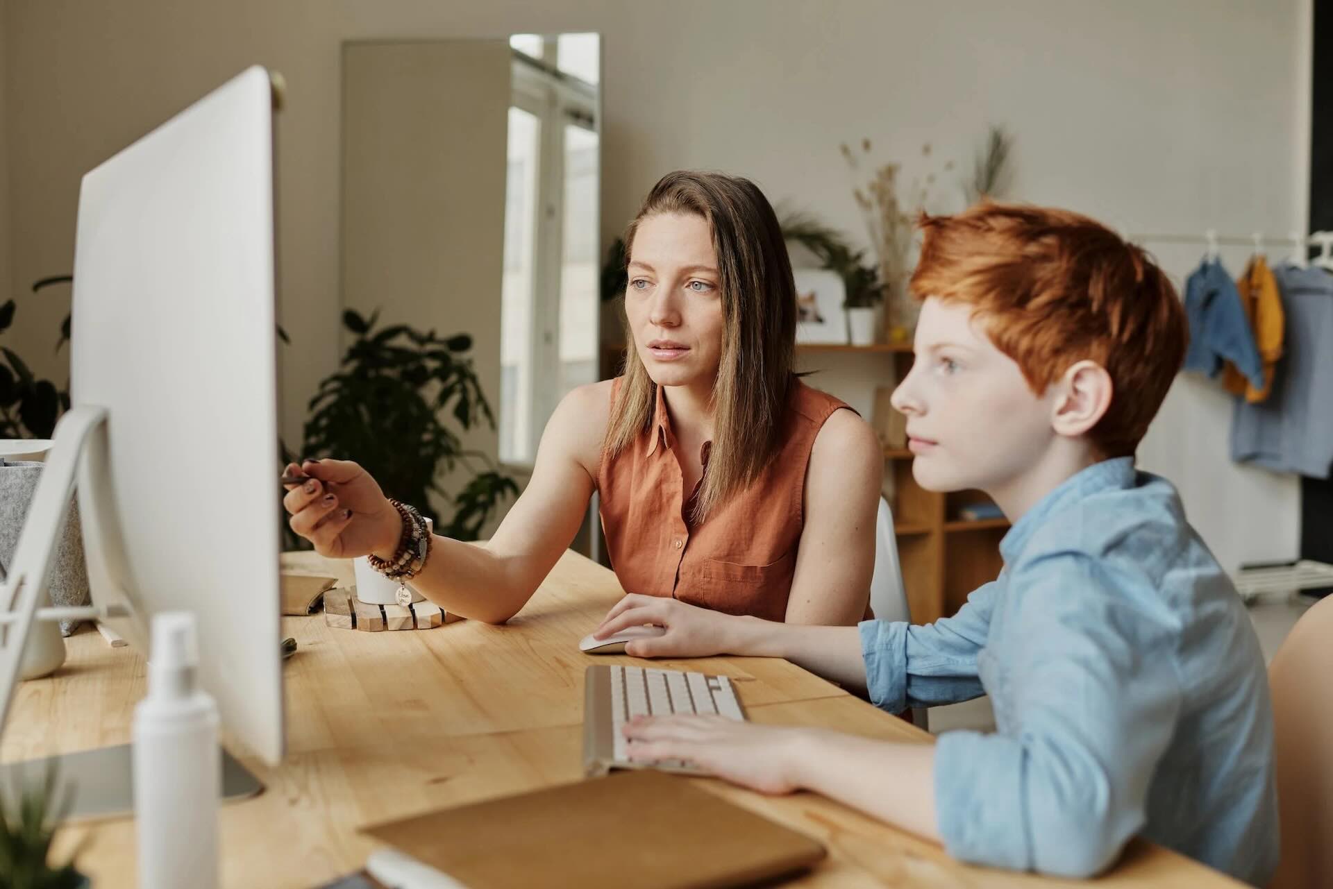 photo-of-woman-tutoring-young-boy